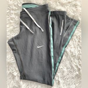 Nike Running. Sz Small. Gray pants with zippers below calves.